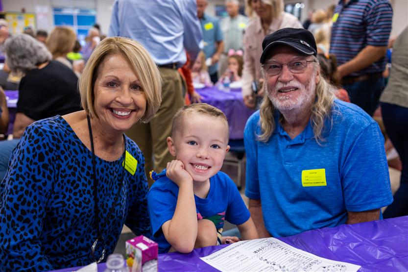 A family smiles at Winstead Elementary's Grandparents Breakfast